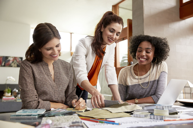 Image: 3 women working at a desk together