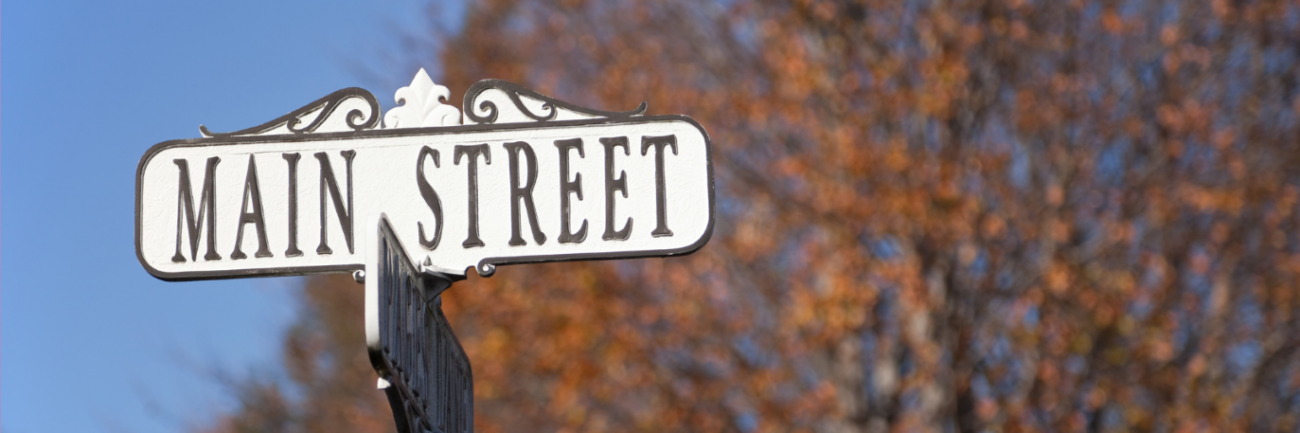 Main Street Main Street sign with the outdoors backdrop
