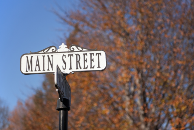 Main Street Main Street sign with the outdoors backdrop